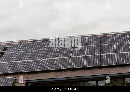 Three rows of solar panels mounted on a roof. Stock Photo