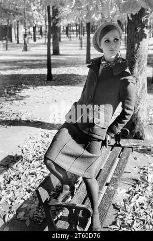 1960s, woman fashion model standing on bench, Jardin des Tuileries garden, Paris, France, Europe, Stock Photo