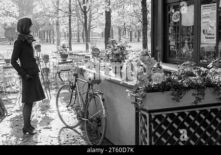 1960s, woman fashion model looking at food and drinks kiosk, Jardin des Tuileries garden, Paris, France, Europe, Stock Photo