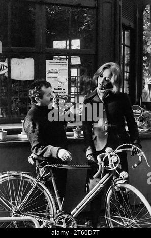 1960s, woman fashion model chatting with food and drink kiosk manager about bikes, Jardin des Tuileries garden, Paris, France, Europe, Stock Photo