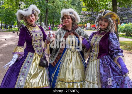 Women dressed in 18th-century costumes in the Admiralty Gardens of the city of St. Petersburg Stock Photo