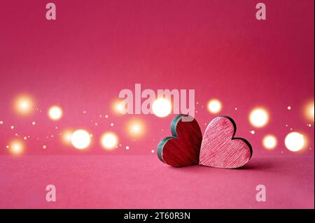 Two red valentines wooden hearts on red background. Stock Photo
