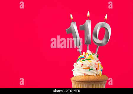 Burning candle number 110 - Birthday card with cake Stock Photo