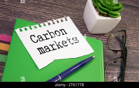 CARBON MARKETS. text on white paper near dollar bills Stock Photo
