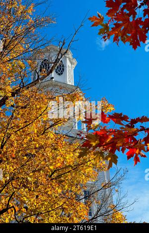 1806 Old First Congregational church bell tower in Bennington Vermont under blue sky brightly lit fall leaf colors Stock Photo