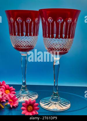 Two clear crystal wine glasses on a blue background Stock Photo