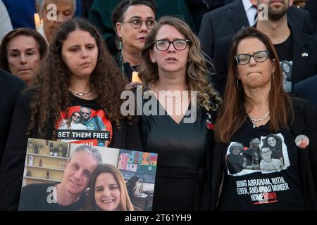 Shani Segal, center, fights back tears as Congressional Members are joined by family members of Israeli victims and Hamas hostages during a bipartisan candlelight vigil at the US Capitol in Washington, DC, Tuesday, November 7, 2023. Ms. Segal's cousin Rimon Buchshtav and her husband Yagev were taken hostage by Hamas militants during the historic and deadly Hamas attack of October 7, 2023. Credit: Rod Lamkey/CNP /MediaPunch Stock Photo