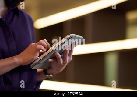 Hands of female entrepreneur checking report on digital tablet Stock Photo