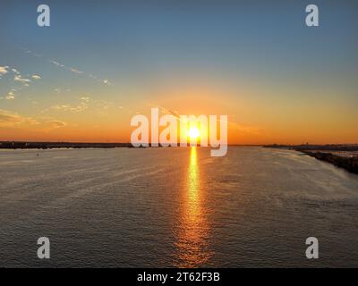 Aerial View of Sun Setting over the Water Stock Photo