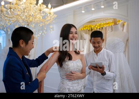Couple choose dress at wedding studio. Lifestyle and wedding concept. Stock Photo