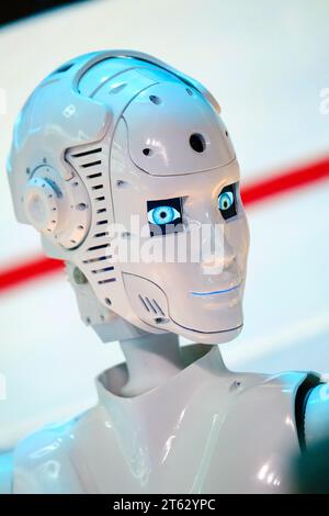 Closeup of white illuminated human robot looking away against blurred background Stock Photo