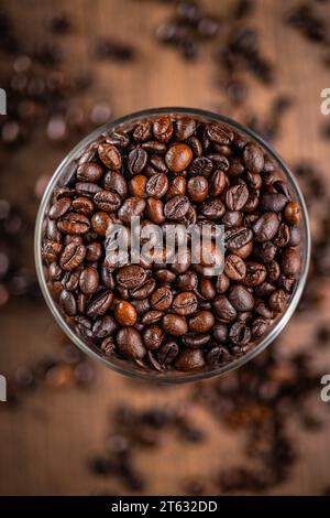 Roasted coffee beans in the bowl. Top view. Stock Photo
