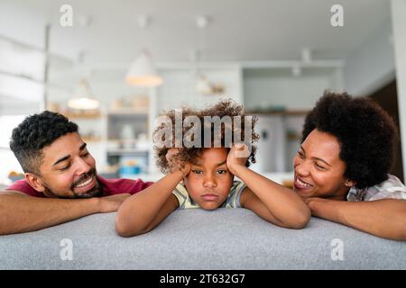 Positive Parents And Teenage Offended Daughter At Home Making Peace 