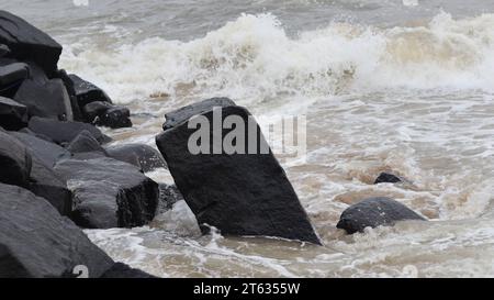Waves splashing the rocks on the beach Stock Photo