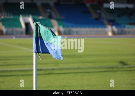 Blue and Green Football Corner Flag on Side of Pitch in a Stadium Stock Photo