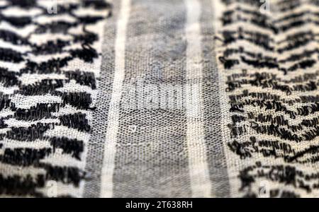 close-up of a Palestinian headscarf or kufiya. The traditional black and white headscarf of the Arab man (Keffiyeh). The weave forms a central path Stock Photo