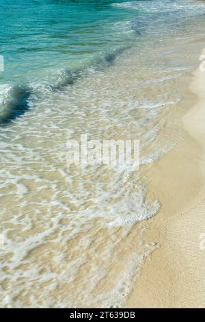 Close up of clear transparent water and white sand on a tropical beach background Stock Photo