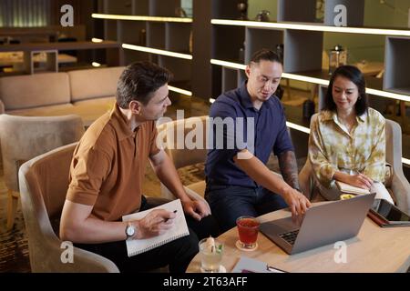 Diverse business team discussing project launch and writing down ideas Stock Photo