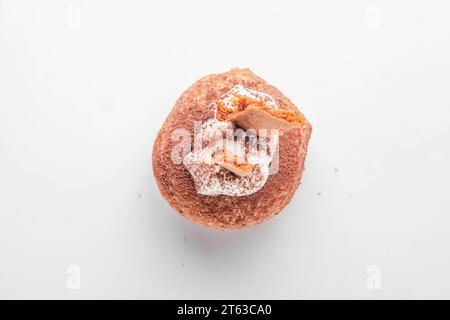 Tiramisu fancy brioche doughnut with topping of honey biscuits and whipped cream. Stock Photo