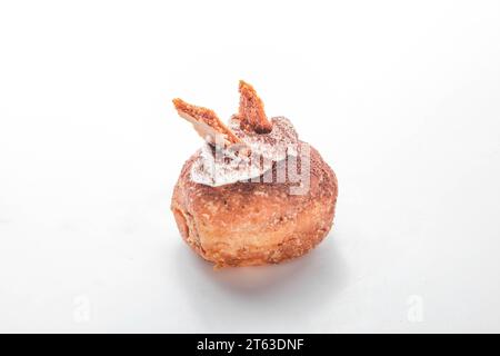 Tiramisu fancy brioche doughnut with topping of honey biscuits and whipped cream. Stock Photo