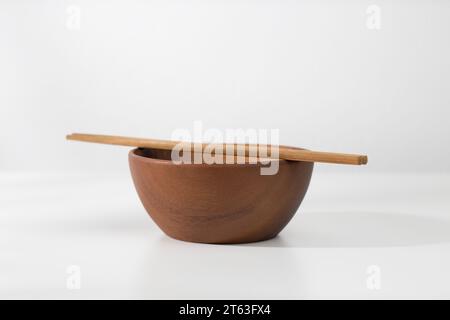 A vacant wooden bowl and chopsticks on the table. Stock Photo