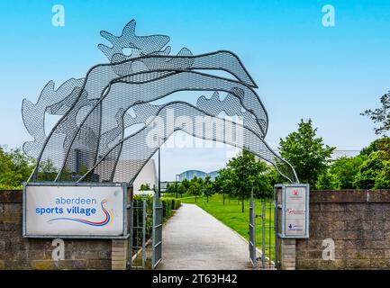 Sculpture of swimmers' legs at the entrance to the Aberdeen Sports Village and Aquatics Centre, Aberdeen, Scotland, UK Stock Photo