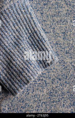 Close-up view of crop textured fabric with parallel vertical lines set against a speckled blue-gray background Stock Photo