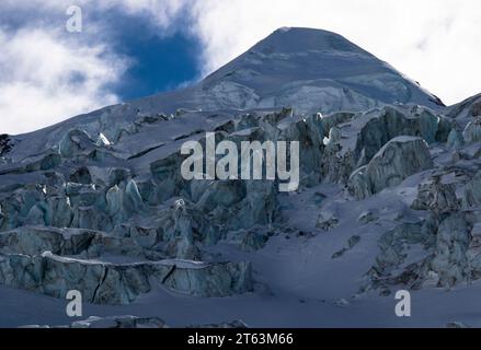 Picturesque view of ice formations on snow covered mountain against sky during winter Stock Photo