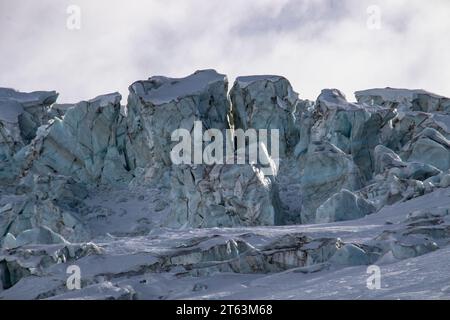 Picturesque view of ice formations on snow covered mountain against sky during winter Stock Photo