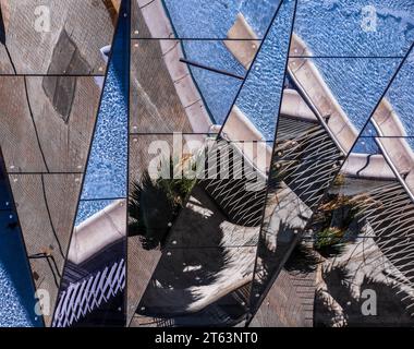 Top-down view of an urban plaza with glass panels, swimming pool, and modern architectural features Stock Photo