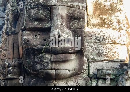 Stone face of Buddha on the ruins of the ancient temple of Bayon. Angkor Thom. Cambodia Stock Photo