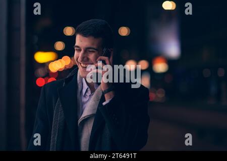 Smiling Meedle Eastern man walking down street near modern office building, Stock Photo