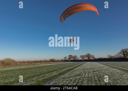 Para Glider following the lines coming in to land on a para-glider with an orange sail Stock Photo