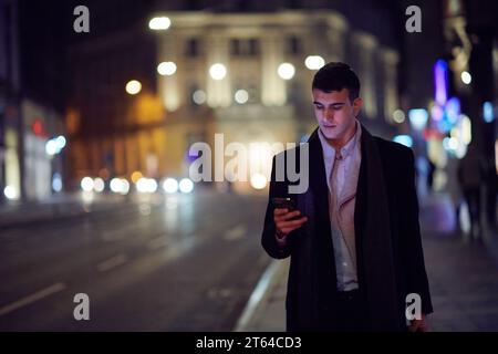 Smiling Meedle Eastern man walking down street near modern office building, Stock Photo