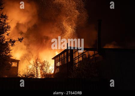 Ukrainian firefighters work to extinguish a fire following an overnight Russian drone strike in Kharkiv on November 3, 2023. Russia launched a massive drone attack early on Friday, hitting critical infrastructure in the west and south of Ukraine and destroying private houses and commercial buildings in Kharkiv, Ukraine's second largest city, officials said. The air force said it shot down 24 'Shahed' drones out of 40 launched by Russia, the biggest drone attack in weeks to target Kharkiv in the northeast, Odesa and Kherson in the south and the region of Lviv on Ukraine's border with Poland in Stock Photo