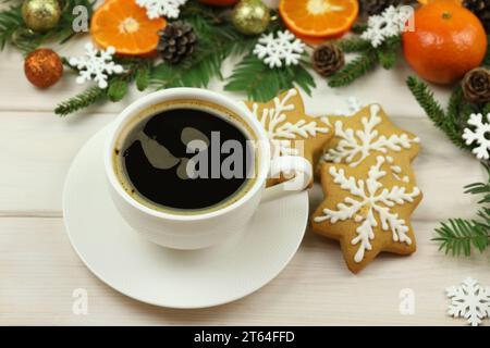 cup of coffee on the white wooden winter background with christmas decorations, tangerines, cones, gingerbread and copy space Stock Photo