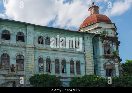 Yangon, Myanmar, 2014. The faded aqua green façade of the old Accountant-General's Office and Currency Department (now the Yangon Division court) Stock Photo