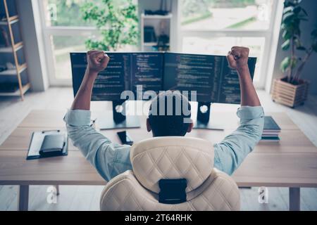 Rear spine photo of winning guy web expert writing code full stack developer done send his project to customer sit desktop in workspace Stock Photo
