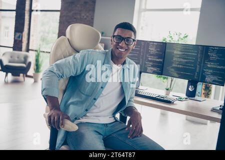 Photo of cheerful middle specialist it company remote job concept guy sitting on armchair when coding programs in home office workplace Stock Photo