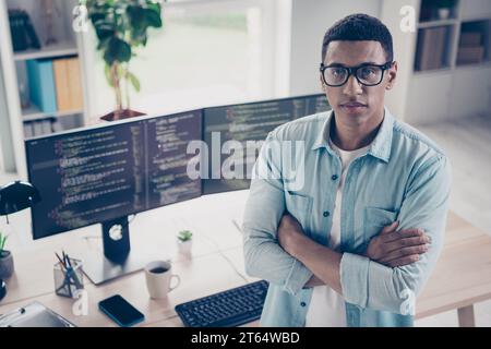 Photo of serious confident businessman outsource freelance programmer folded arms fulfill all tasks at home desktop office background Stock Photo