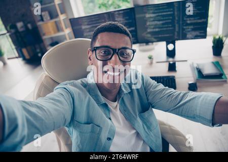 Self portrait of attractive student young positive guy working remotely employee technical support manager at workplace indoors home Stock Photo
