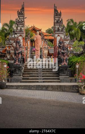 A Buddhist temple in the evening in the rain. The Brahmavihara Arama Temple has beautiful gardens and is also home to a monastery. Tropical plants Stock Photo