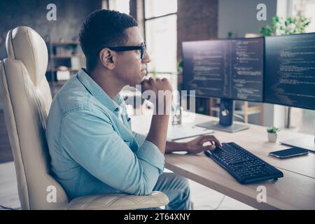 Profile shot of confident data analyst it specialist young guy thinking researching web designers code and brainstorming indoors office Stock Photo