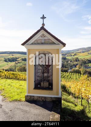 Wayside shrine, vineyards and hills behind, south-east Styrian hills, near St. Anna am Aigen, Styria, Austria Stock Photo