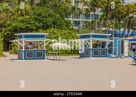 Scenic sight of two service kiosks positioned across from hotel on sandy shores of Miami Beach. USA. Stock Photo