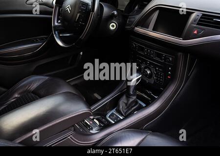 Modern car interior with a multimedia screen and many buttons. Citroen car, gearbox and steering wheel in the frame Stock Photo