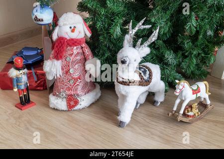 A variety of gifts for children for Christmas are prepared under the green Christmas tree Stock Photo