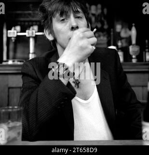 Legendary Irish rockstar, singer/songwriter & frontman for The Pogues & The Popes, Shane MacGowan pictured drinking and smoking at his favourite London pub Filthy MacNasty’s , Islington 1994 Stock Photo