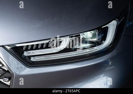 Led light car technology theme. Modern headlight on new gray car Stock Photo