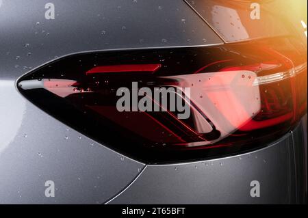 Rear red led tail car light on gray color  close up view Stock Photo